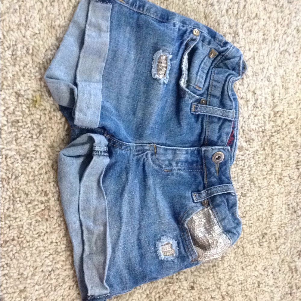 Blue ripped girls jean shorts.